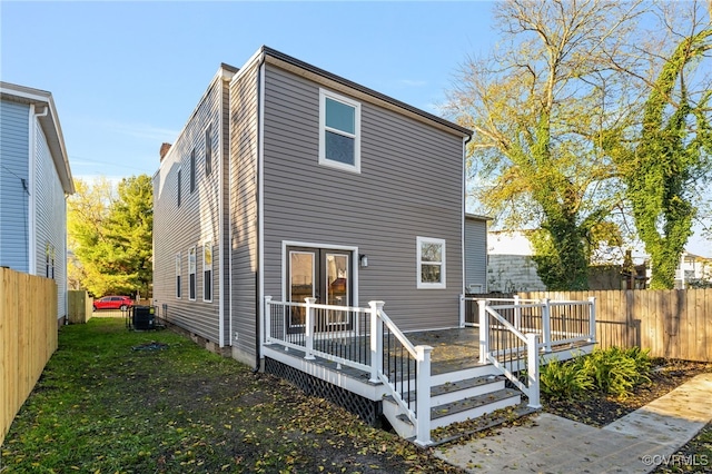 back of property featuring central air condition unit and a wooden deck