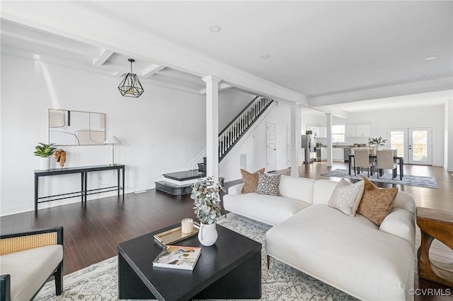 living room with beam ceiling, ornate columns, and hardwood / wood-style floors