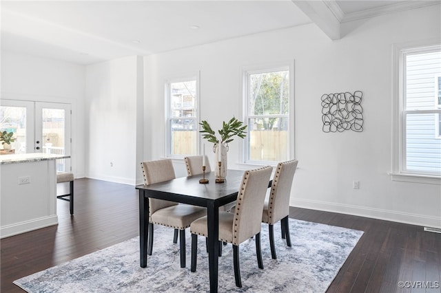 dining room with dark hardwood / wood-style floors, beam ceiling, ornamental molding, and french doors