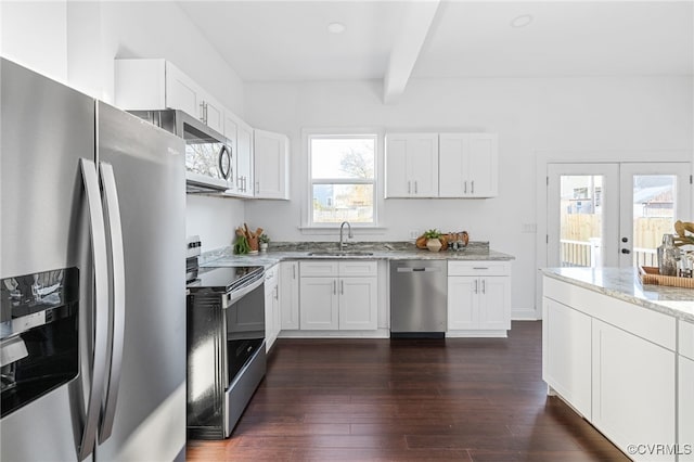 kitchen featuring white cabinetry, plenty of natural light, and stainless steel appliances