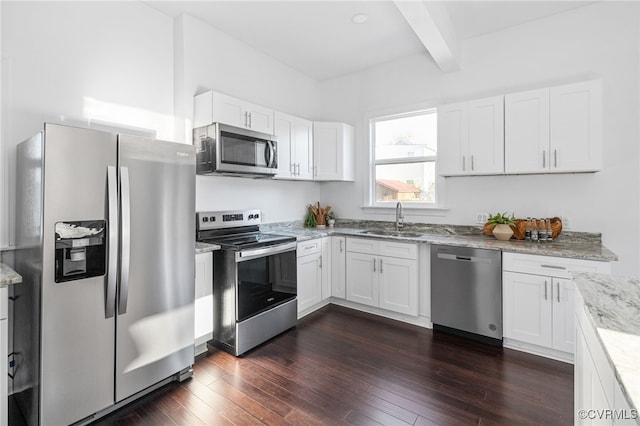 kitchen with dark wood-type flooring, white cabinets, sink, beamed ceiling, and stainless steel appliances