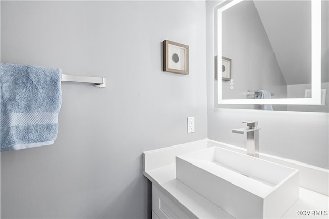 bathroom with vanity and vaulted ceiling