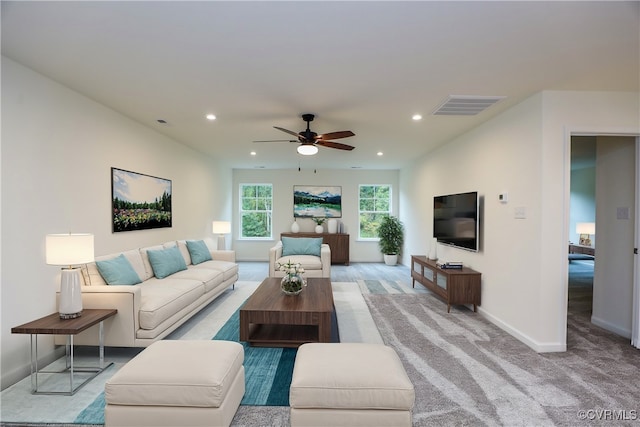 living room with ceiling fan and light colored carpet