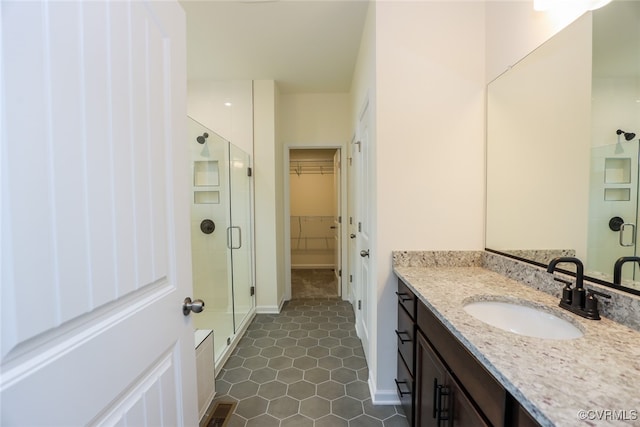 bathroom with vanity, tile patterned floors, and a shower with shower door