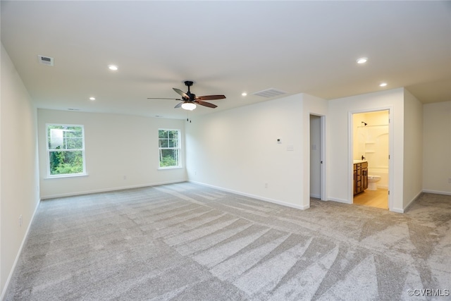 unfurnished room with ceiling fan and light carpet