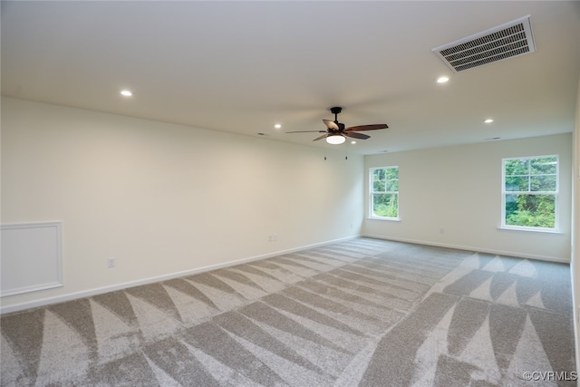 unfurnished room featuring light carpet and ceiling fan