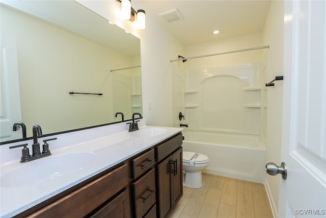 full bathroom with toilet, vanity, hardwood / wood-style flooring, and  shower combination