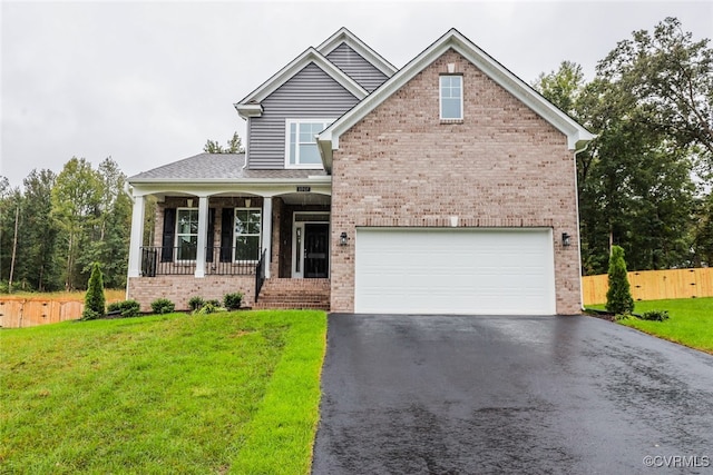 craftsman-style home with a garage, covered porch, and a front yard