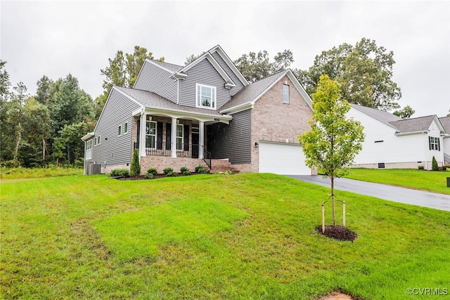 craftsman inspired home with a front yard, central AC, and a porch