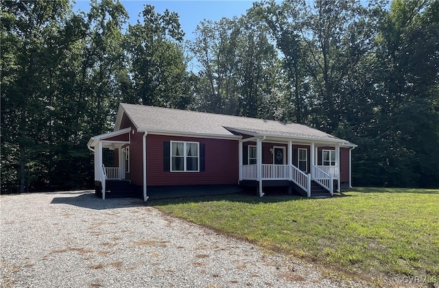 single story home with covered porch and a front yard