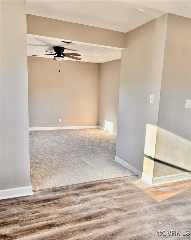 unfurnished room with ceiling fan and wood-type flooring