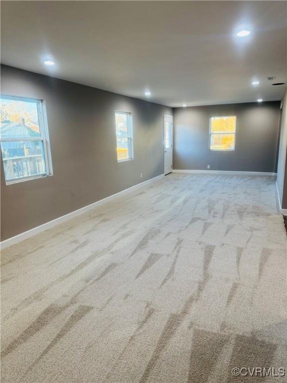 basement featuring light carpet