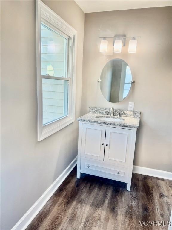 bathroom with vanity and hardwood / wood-style flooring