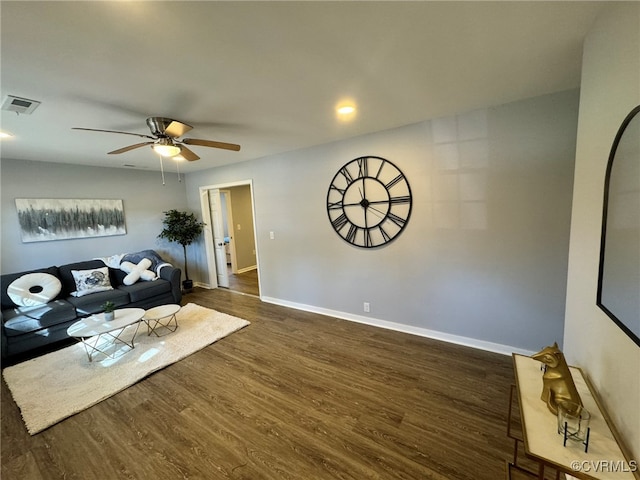 unfurnished living room with dark wood-type flooring and ceiling fan