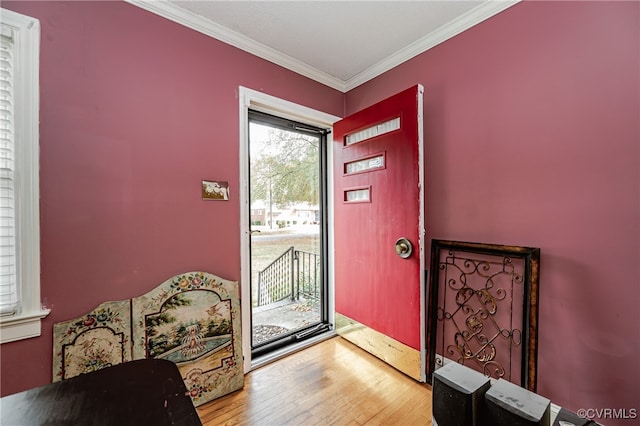 foyer entrance featuring wood-type flooring and crown molding