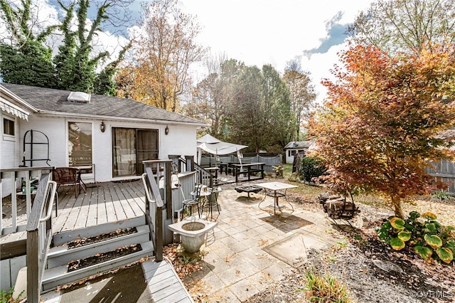 view of patio featuring a wooden deck and an outdoor fire pit