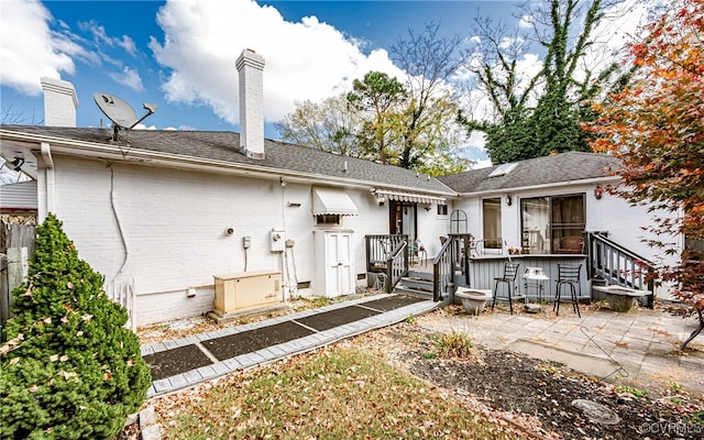 back of property with a wooden deck