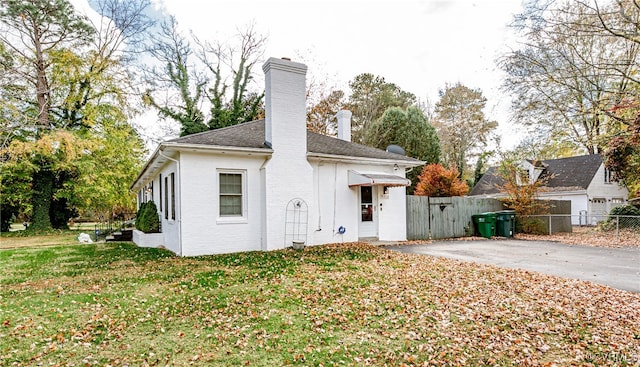 rear view of property with a yard