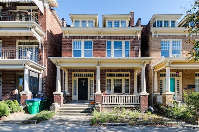 view of front facade with a balcony and a porch