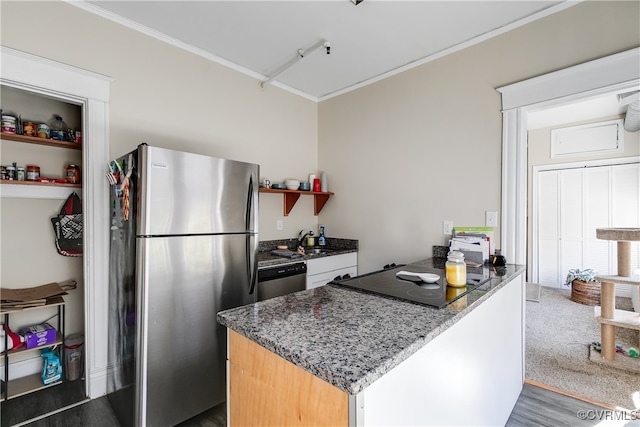 kitchen with ornamental molding, appliances with stainless steel finishes, sink, dark wood-type flooring, and dark stone countertops