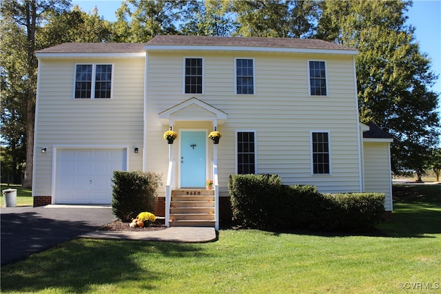 view of front facade featuring a front yard and a garage