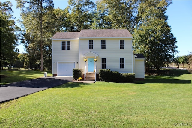 colonial-style house featuring a front lawn and a garage