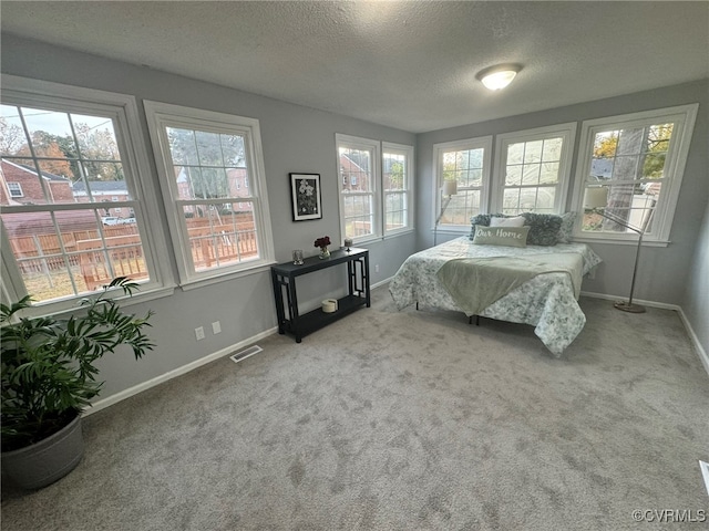 carpeted bedroom with a textured ceiling