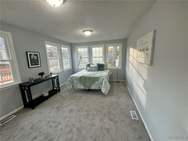 carpeted bedroom featuring a textured ceiling