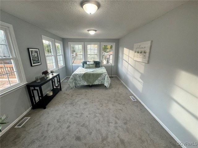 unfurnished bedroom with carpet and a textured ceiling