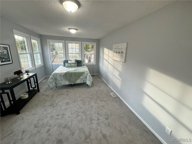 unfurnished bedroom with carpet flooring and a textured ceiling