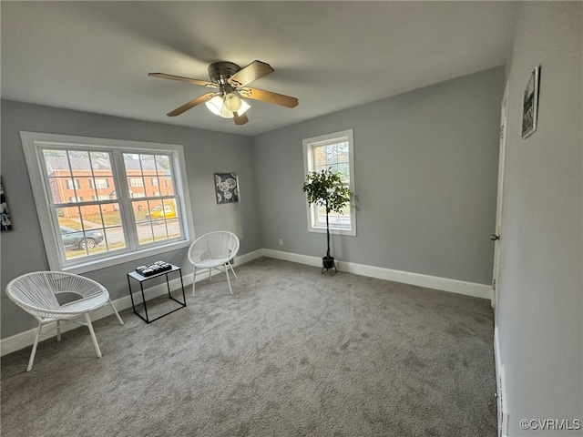 unfurnished room featuring ceiling fan, light carpet, and a healthy amount of sunlight