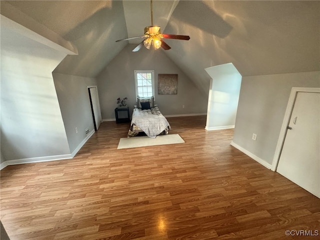 unfurnished bedroom featuring light hardwood / wood-style floors, ceiling fan, and lofted ceiling