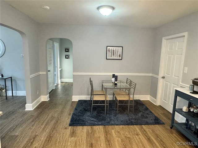 dining room with dark hardwood / wood-style flooring