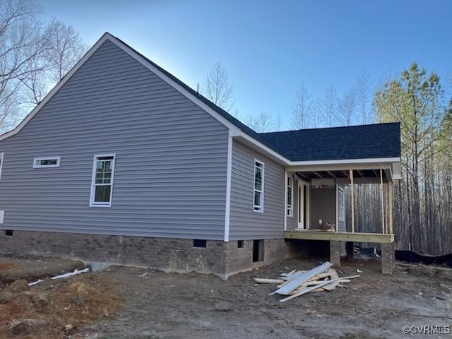 view of side of home featuring a porch