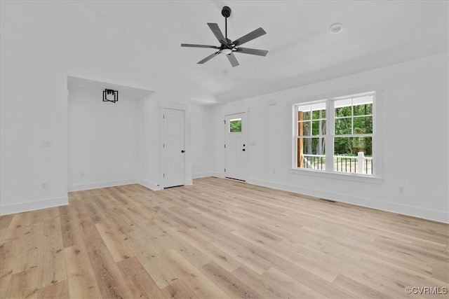 unfurnished living room featuring visible vents, vaulted ceiling, ceiling fan, light wood-style flooring, and baseboards