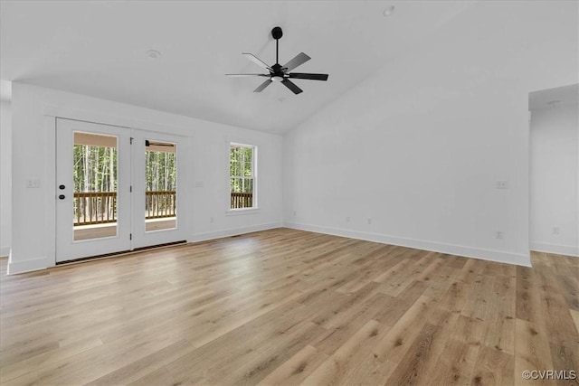 unfurnished living room featuring light wood finished floors, a wealth of natural light, and a ceiling fan