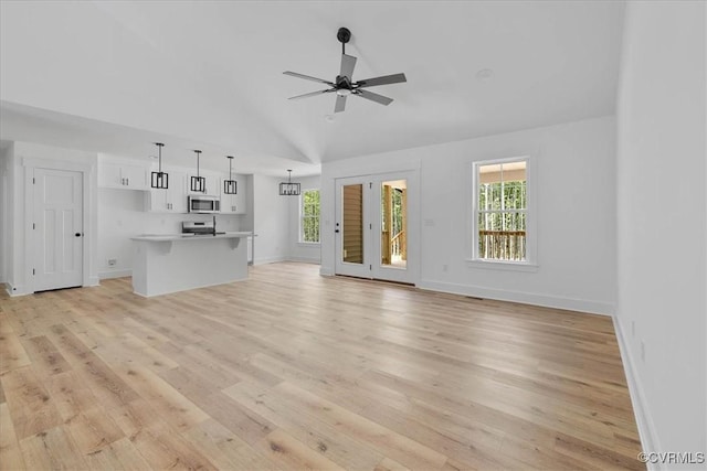 unfurnished living room with a wealth of natural light, ceiling fan, and light wood-type flooring
