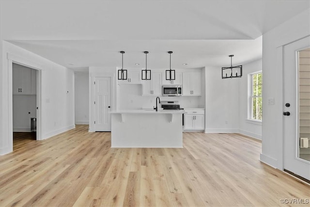 kitchen featuring white cabinetry, light countertops, stainless steel appliances, and baseboards
