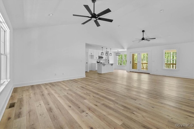 unfurnished living room featuring light wood finished floors, high vaulted ceiling, visible vents, baseboards, and ceiling fan
