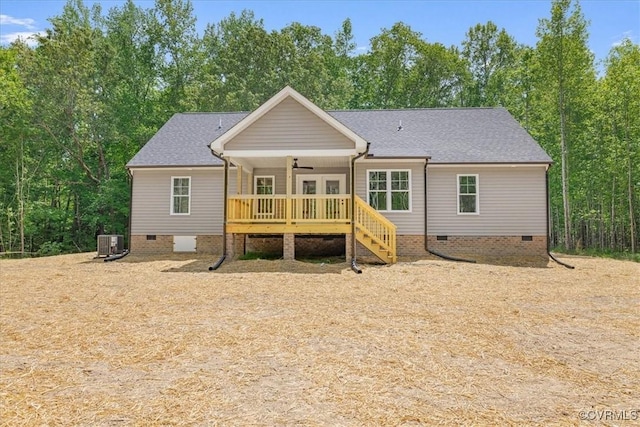 rear view of house featuring central air condition unit, a shingled roof, crawl space, and stairway