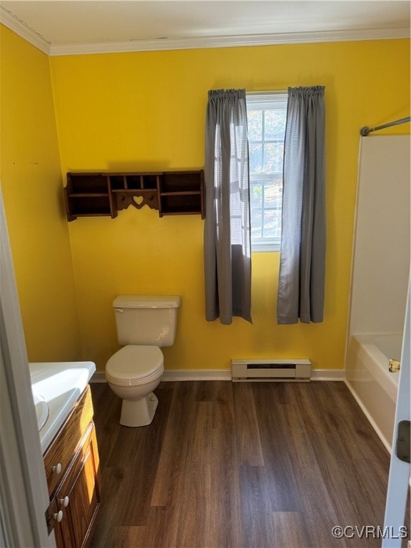 bathroom featuring crown molding, vanity, hardwood / wood-style floors, a baseboard heating unit, and toilet