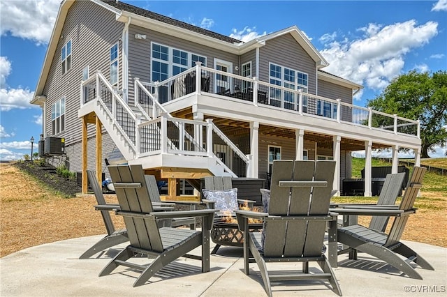 rear view of property featuring central air condition unit and a patio