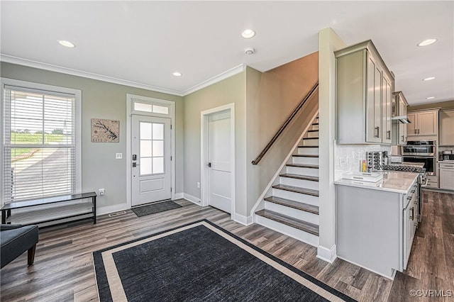 entrance foyer featuring dark hardwood / wood-style floors and crown molding