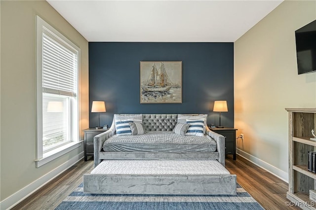 bedroom with dark wood-type flooring