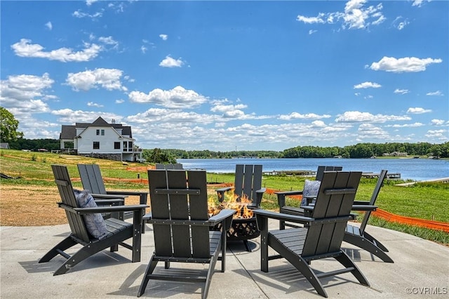 view of patio with a fire pit and a water view