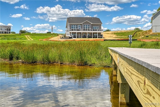 view of dock featuring a water view and a balcony