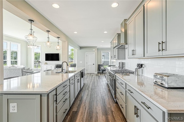 kitchen featuring gray cabinetry, dark hardwood / wood-style flooring, sink, and hanging light fixtures