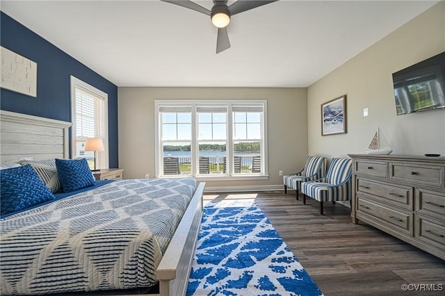 bedroom with ceiling fan and dark wood-type flooring