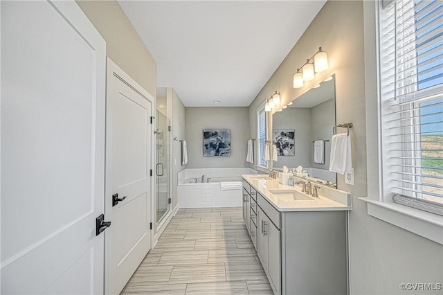 bathroom with vanity and separate shower and tub