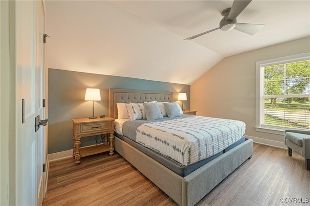 bedroom featuring hardwood / wood-style floors, ceiling fan, and lofted ceiling